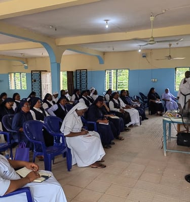 A group of Catholic nuns in habits attend a religious seminar or educational workshop in a classroom.