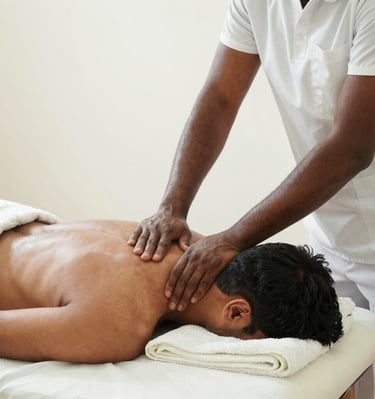 An elderly woman laughing warmly as the RMT therapist gently massages her neck, with soft sage green walls in the background.