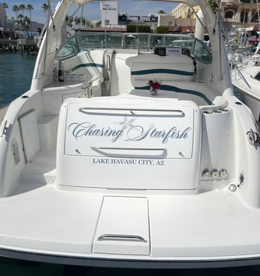 White motorboat named Chasing Starfish docked at a Lake Havasu City marina in Arizona.