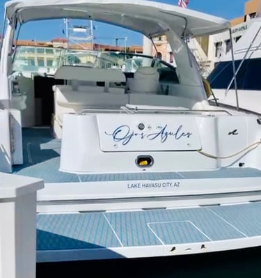The stern of a white luxury motorboat named Ojos Azules docked at Lake Havasu City, Arizona.