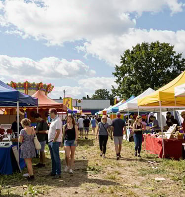 Close-up of rustic coffee beans spilling from a burlap sack onto a weathered wooden surface.