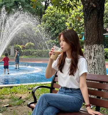 A solo traveler enjoying a cup of coffee at a cozy outdoor café with a scenic mountain view.