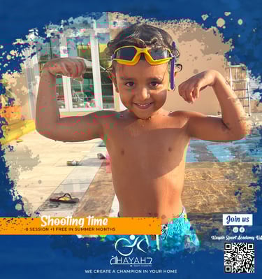 Young boy flexing muscles at a swimming pool during Hayah Sport Academy summer lessons.