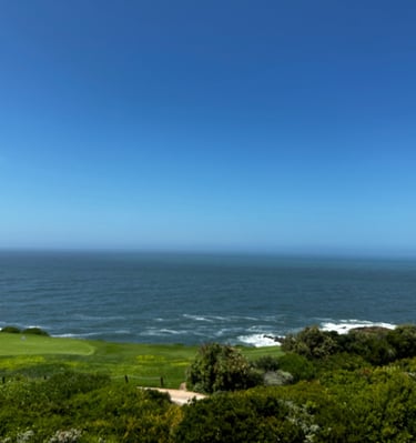 a golf course with a view of the ocean