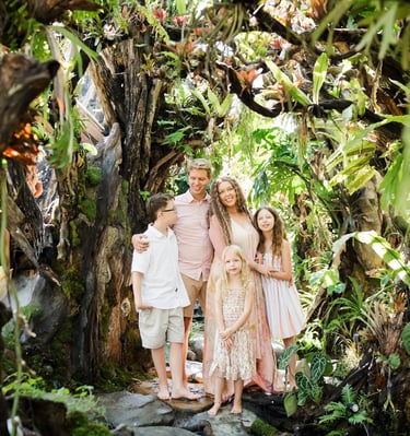 Family walking through the lush garden pathway at Umbul Sari Water Garden in Ubud Bali