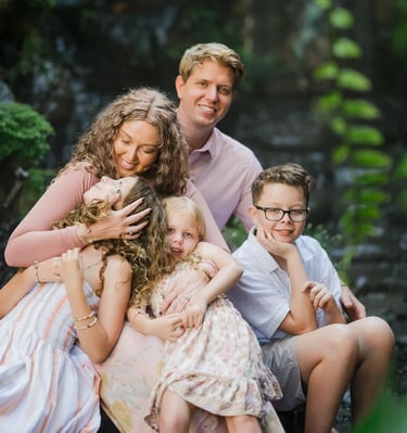 Relaxed family portrait surrounded by tropical greenery in Ubud Bali