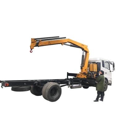 A man stands beside a robust crane with a 6.3 Ton Knuckle Boom. The crane's hexagon and pentagon boom design ensures stabilit