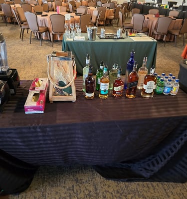 a table with a table cloth covered with bottles of alcohol
