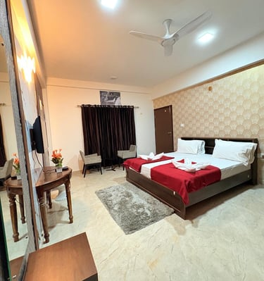 a bedroom with a bed and a television