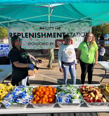 Volunteers at the fruit and replenishment station at the Tuscaloosa Mayor's Cup race