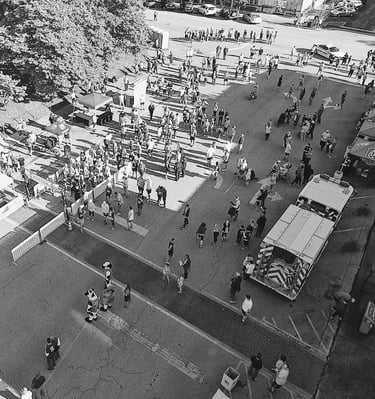 an overhead drone shot of the starting line and expo booths of the North Alabama Chick Fil A 10K