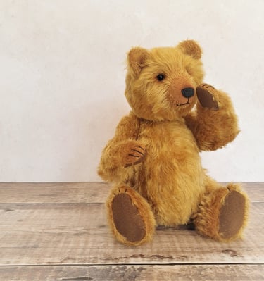 a handmade teddy bear sitting on a table