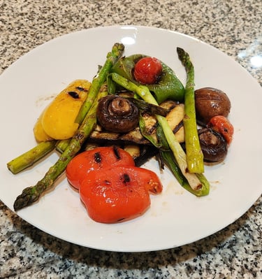 a plate on a counter with grilled vegetables
