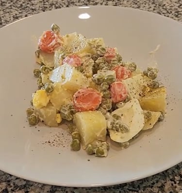 a plate on a counter with Russian salad