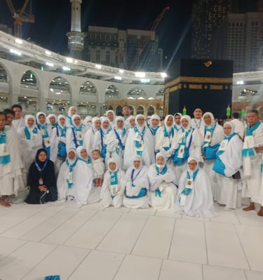 a group of people standing around a group of people in white robes