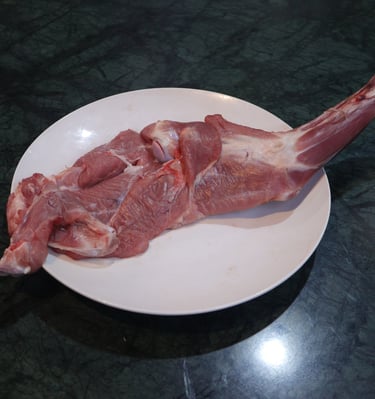 a piece of  shoulder meat on a plate with a piece of meat on it