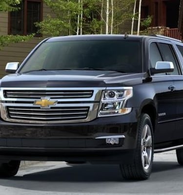 Black Chevy Suburban luxury SUV used for premium transportation services.