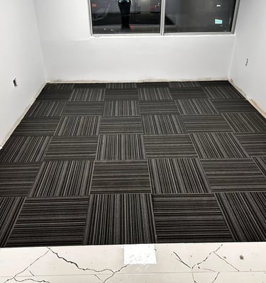 Office room with black commercial carpet tile, line design, quarter-turn install in Downtown London ON