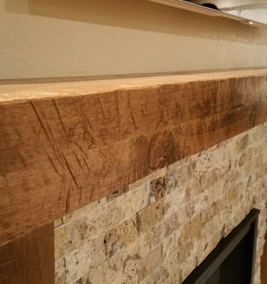 Custom reclaimed wood beam mantle and stone work fireplace surround. Colorado Springs fireplace remodels.