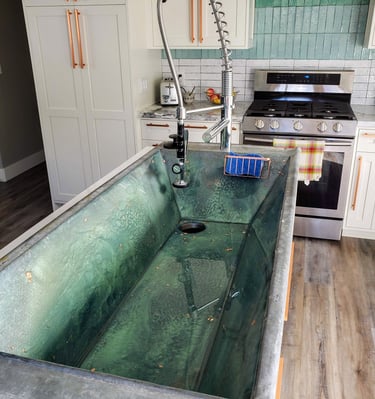 Custom French batch sink with sea green epoxy. Custom remodels Colorado Springs.