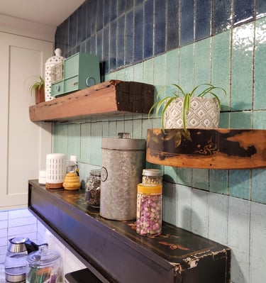 Unique custom kitchen shelves on hombre wall tile work.  Shelves made from antique wooden boxes and reclaimed posts.