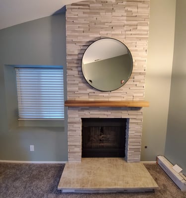 Stone work fireplace surround with reclaimed wood beam mantle, granite hearth. Colorado Springs hearth work.