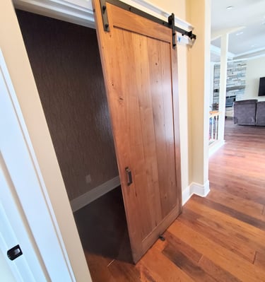 Sliding barn door in natural wood tones. Colorado Springs.