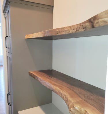 live edge shelving attached to grey cabinets on smooth textured walls.