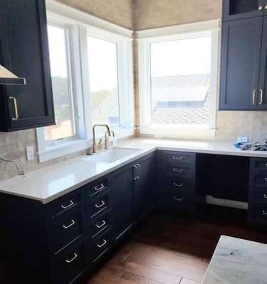 Modern renovated kitchen with custom black cabinetry and brass hardware. Colorado Springs kitchen update.