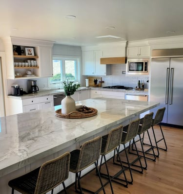 Renovated bright open kitchen with large center island, custom wood work on range hood. Colorado Springs.
