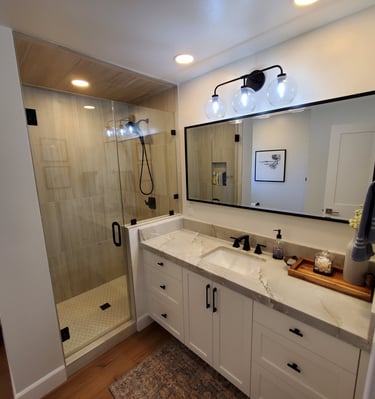Compete bathroom renovation with recessed lights, sleek shower and counter top. personalized bathrooms Colorado Springs.