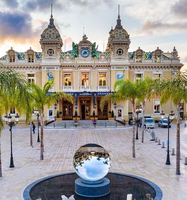 a fountain with a statue of a man in front of a building