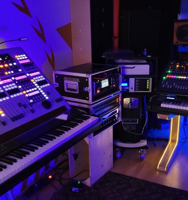 three audio mixers in a music studio with a keyboard and a keyboard