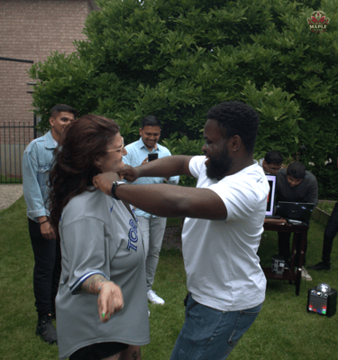 a man and woman dancing in a yard