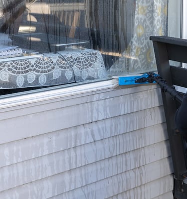 Man Cleaning Window Frame