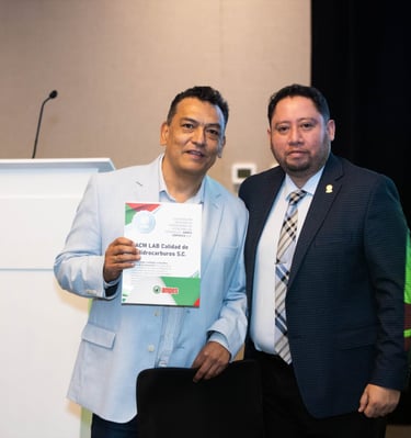 Two professional men holding a certificate at an AMPES event for hydrocarbon quality control.
