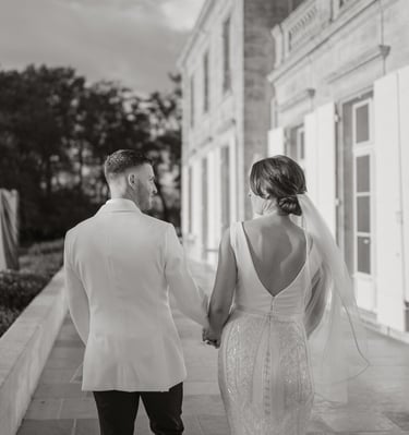 a bride and groom walking down a sidewalk wedding in Bordeaux Château Gassies