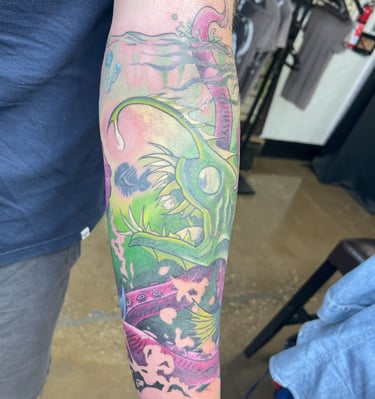 a man with a tattoo on his arm color fish and octopus