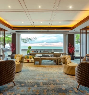 a living room with a large window and a view of the ocean