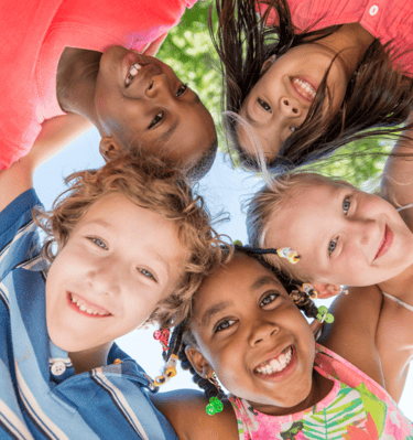 a group of smiling children standing in a circle