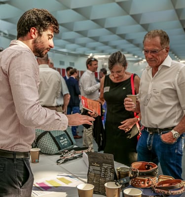 Deux hommes et une femme qui discutent autour d'un stand d'accessoires pour animaux de compagnie