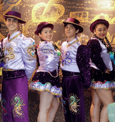 a group of young people in colorful costumes