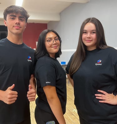 three people standing in a room