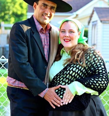 a man and woman in a Chilean hat and a black dress
