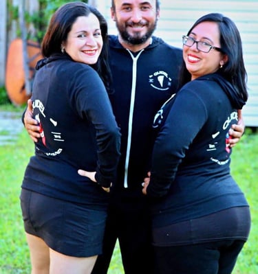 a man and woman in matching black outfits