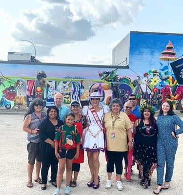 a group of people standing in front of a mural