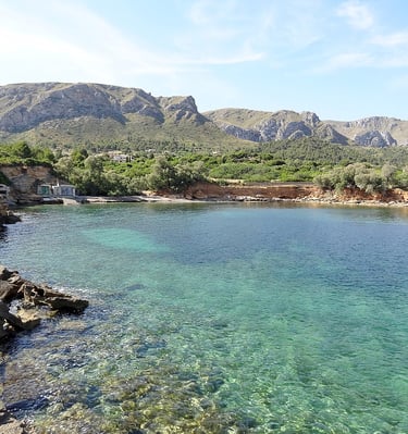 a body of water with a mountain in the background