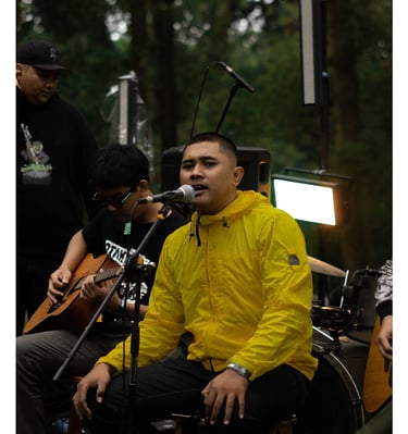 a man in a yellow jacket and a guitar