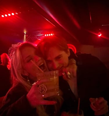 a couple is posing at the bar