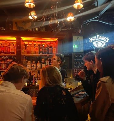 a group of people standing around a bar in Riga